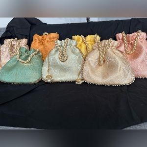 Beautiful handcrafted potluck bags with pearl handle made up of brocade fabric.